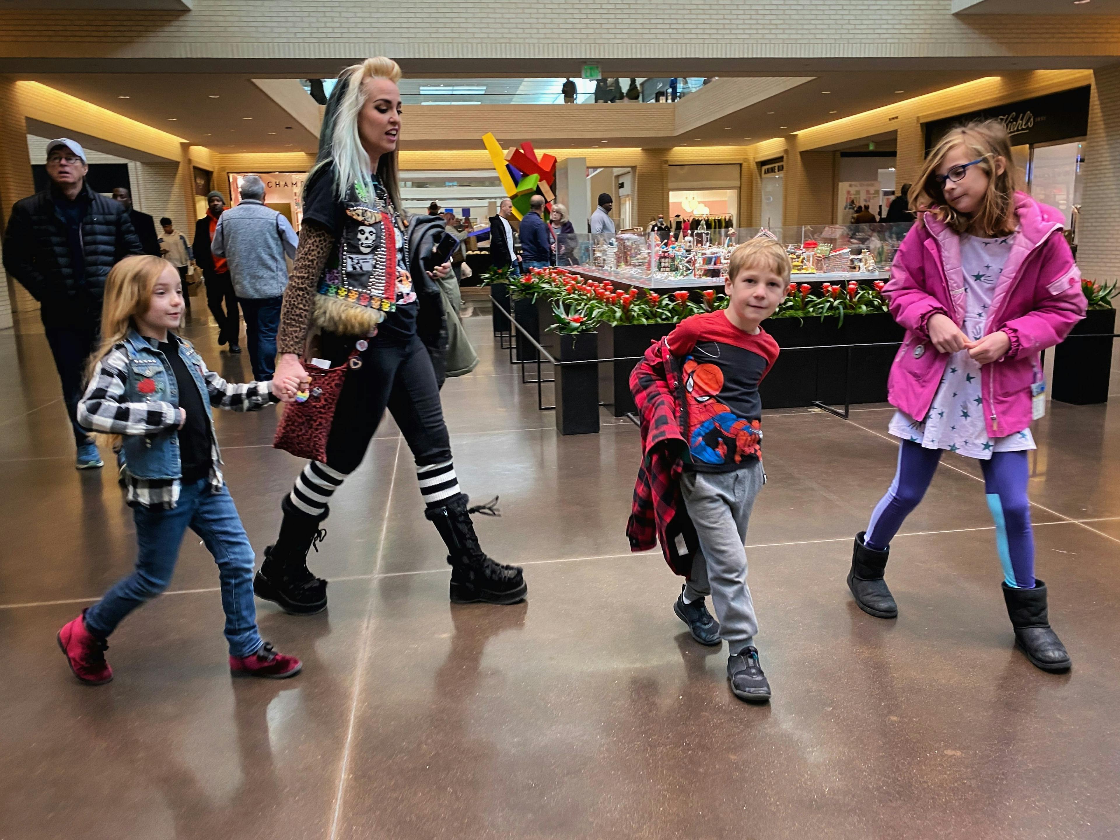 Woman and kids walking in  a mall